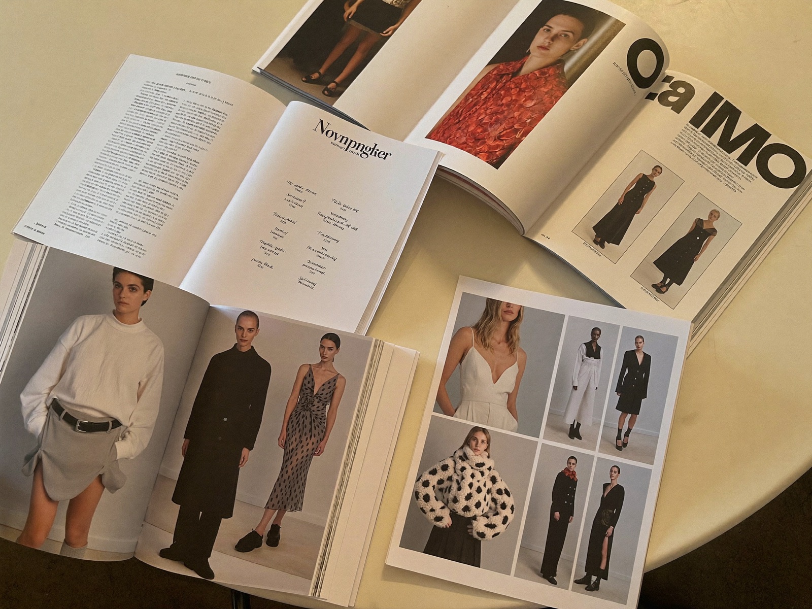 Editorial magazine spreads and contact sheets on a table